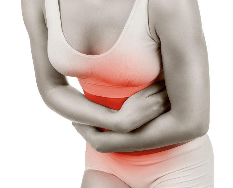 woman clutching stomach in pain. radiating red color where pain is.