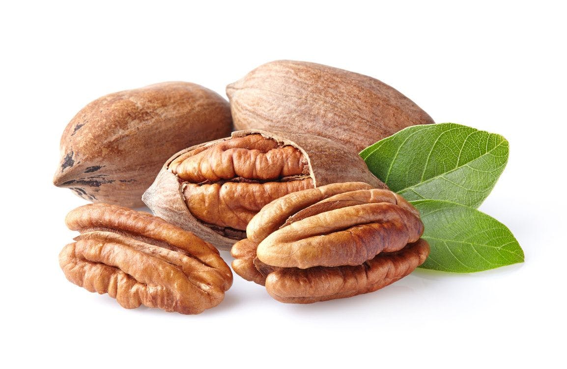 shelled and unshelled pecans on white background