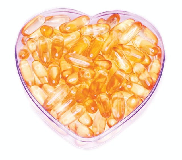 heart shaped petri dish with fish oil supplements
