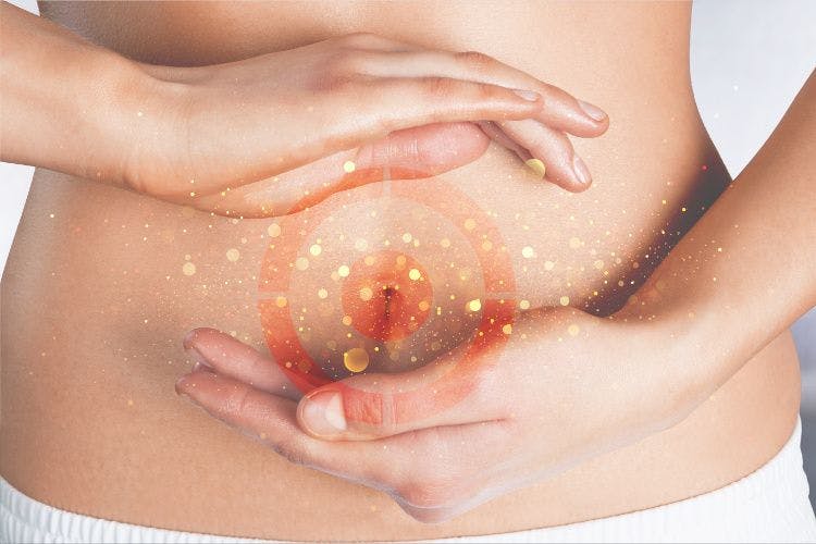 woman with hands on stomach and target on belly between hands