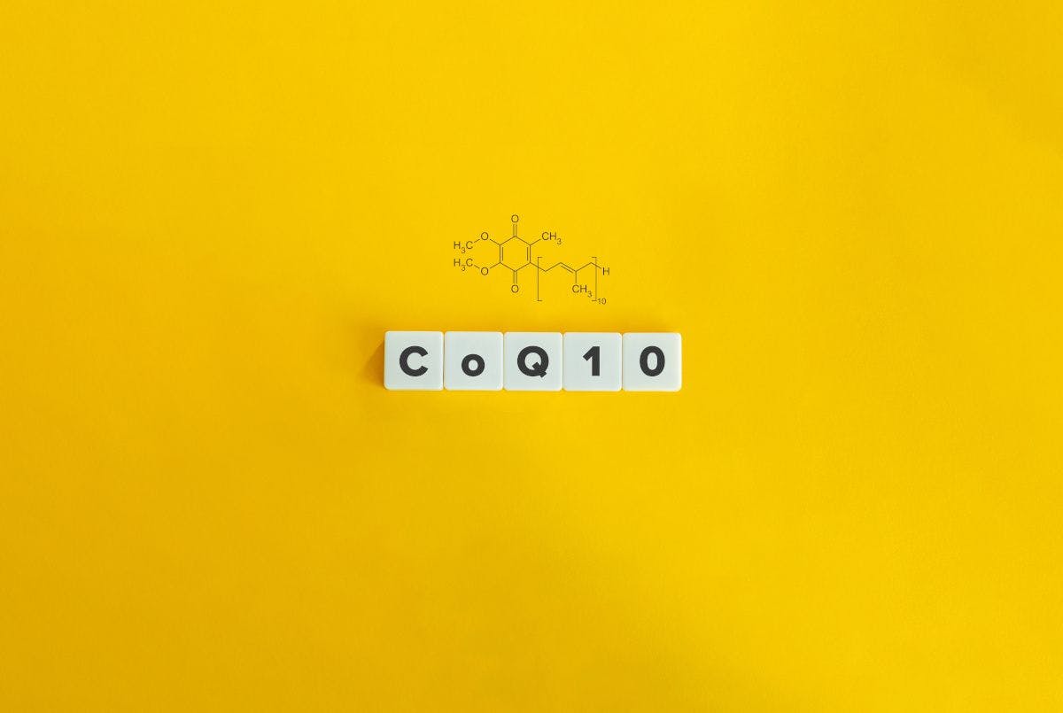 tiles that spell out CoQ10 on yellow background