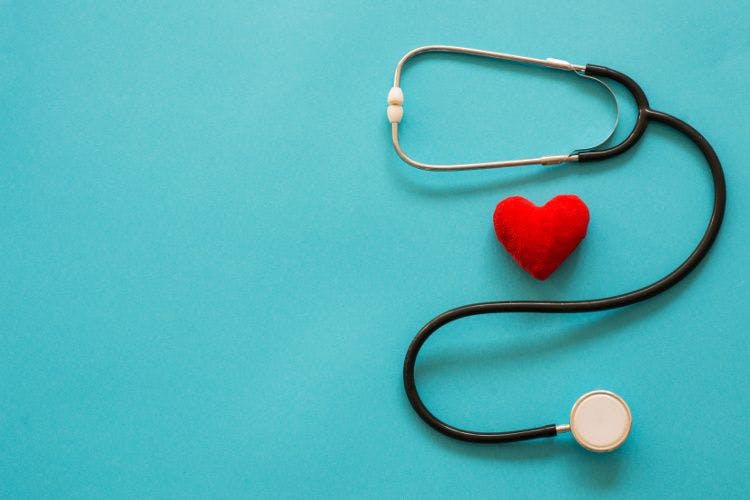 stethoscope and plush heart on blue background
