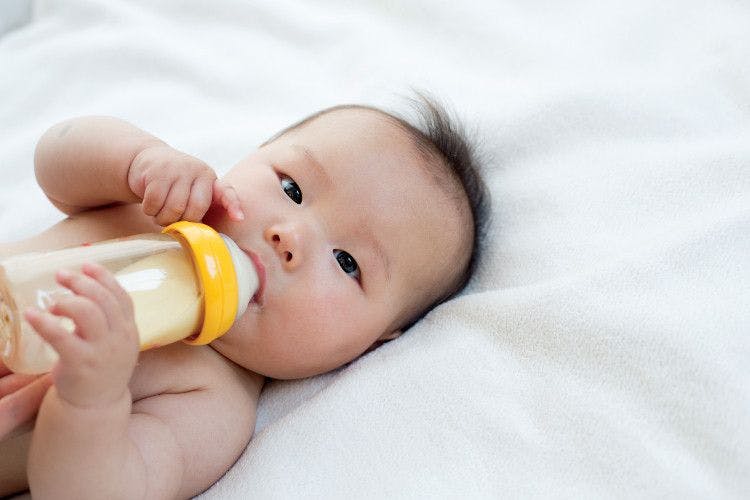 baby drinking formula from bottle