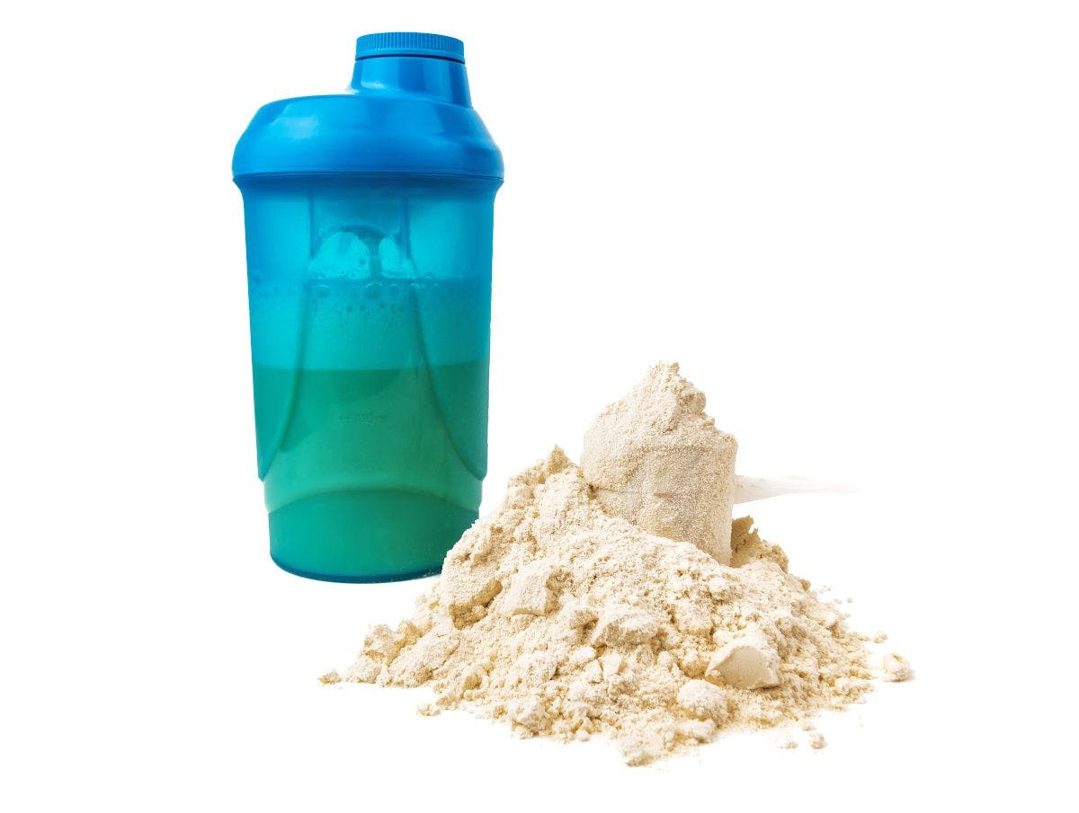 bottle and mound of protein powder