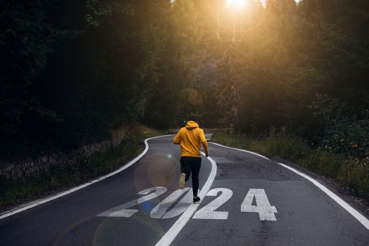 man running on road that has 2024 written on it. 