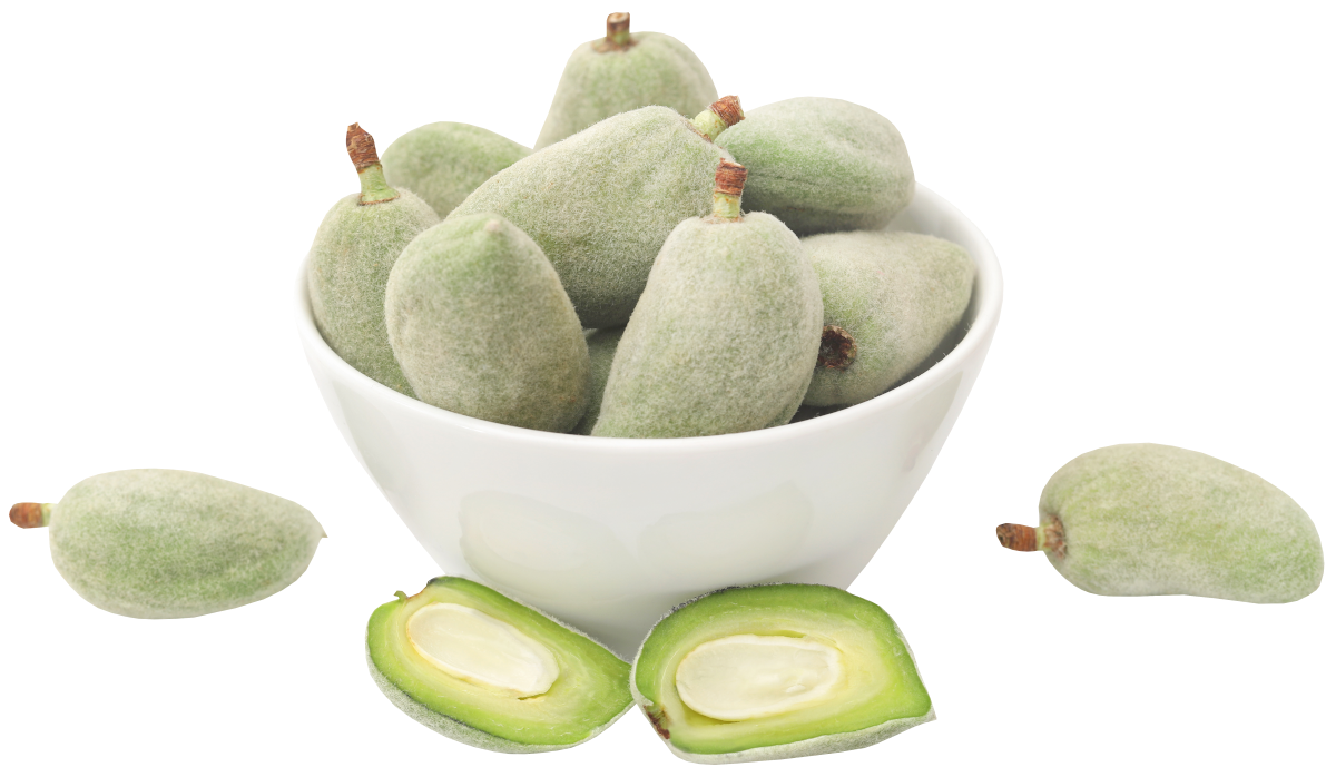 bowl of green almonds with on split in half